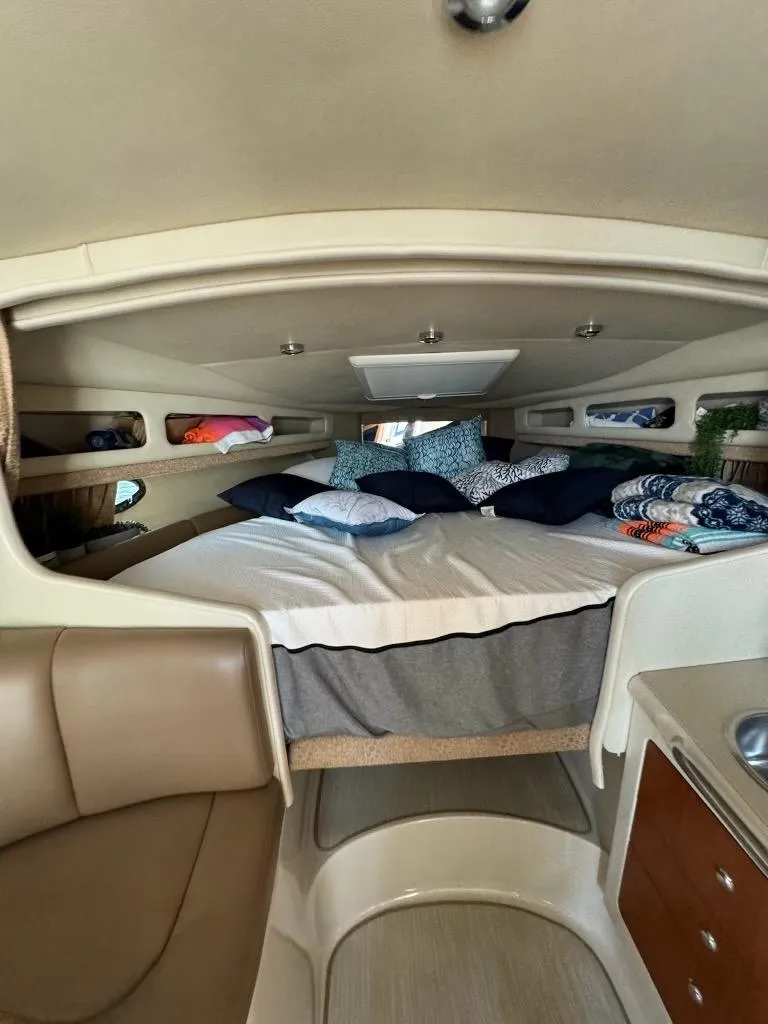 Slide: The Image of 2003 Chaparral Signature 280 cabin interior with cozy bed and modern amenities. - 20