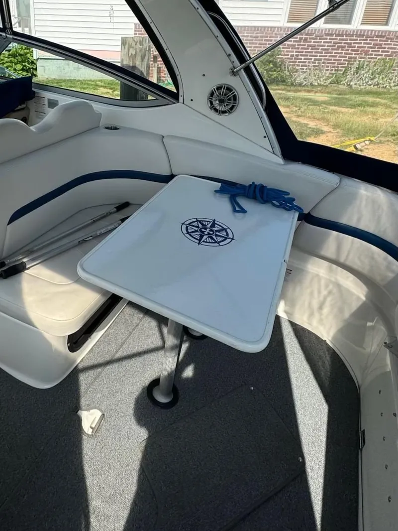 Slide: The Image of 2003 Chaparral Signature 280 interior with table and seating, featuring nautical design elements. - 3