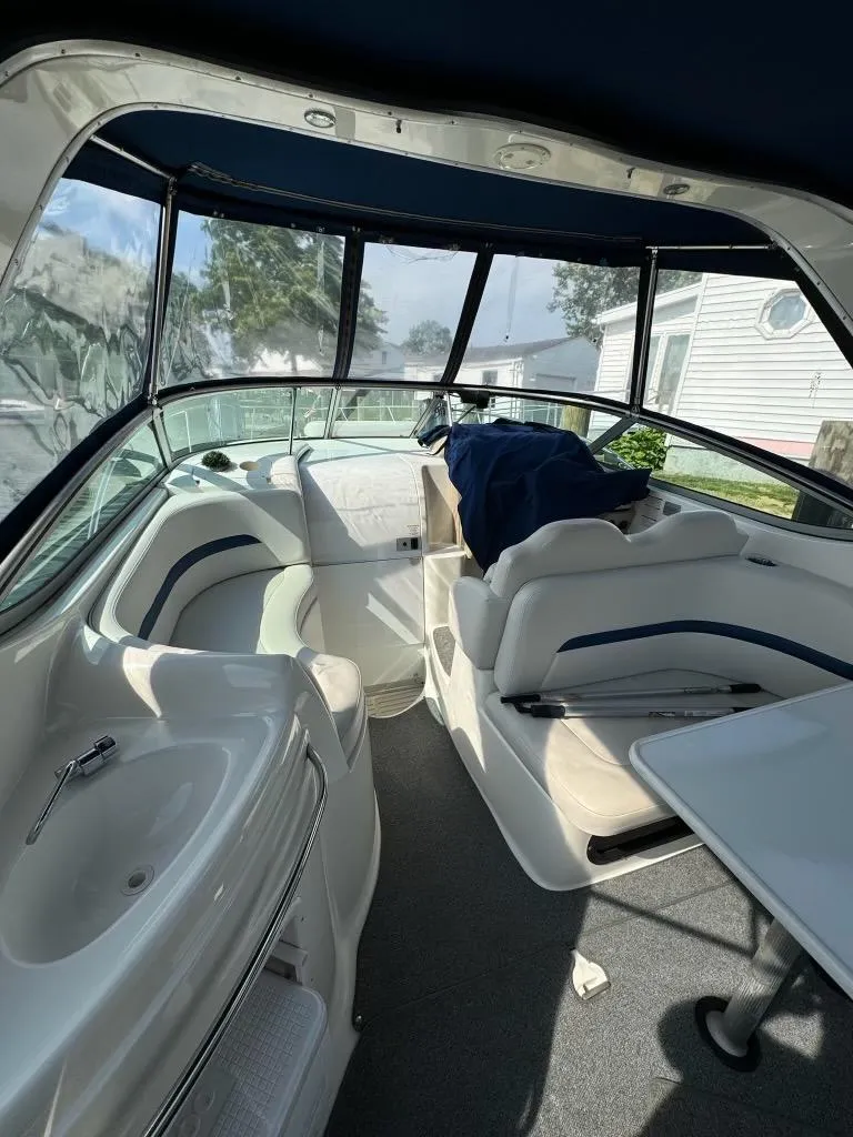 Slide: The Image of 2003 Chaparral Signature 280 boat interior with seating and helm, featuring sleek design. - 4
