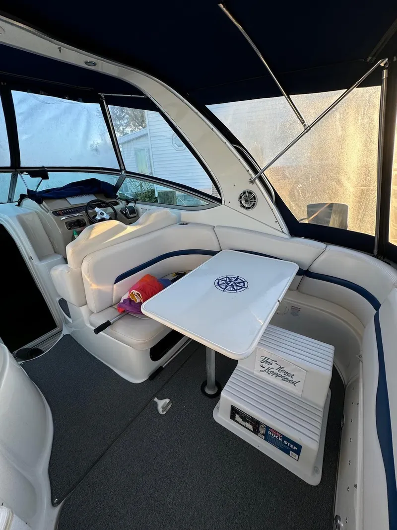 Slide: The Image of 2003 Chaparral Signature 280 boat interior with seating and table, featuring a nautical theme. - 6