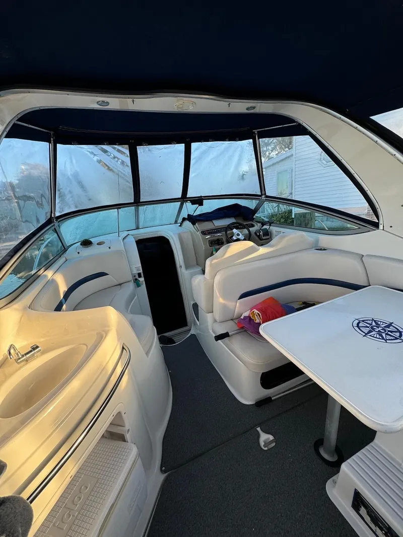 Slide: The Image of 2003 Chaparral Signature 280 boat interior with seating and table under canopy. - 7