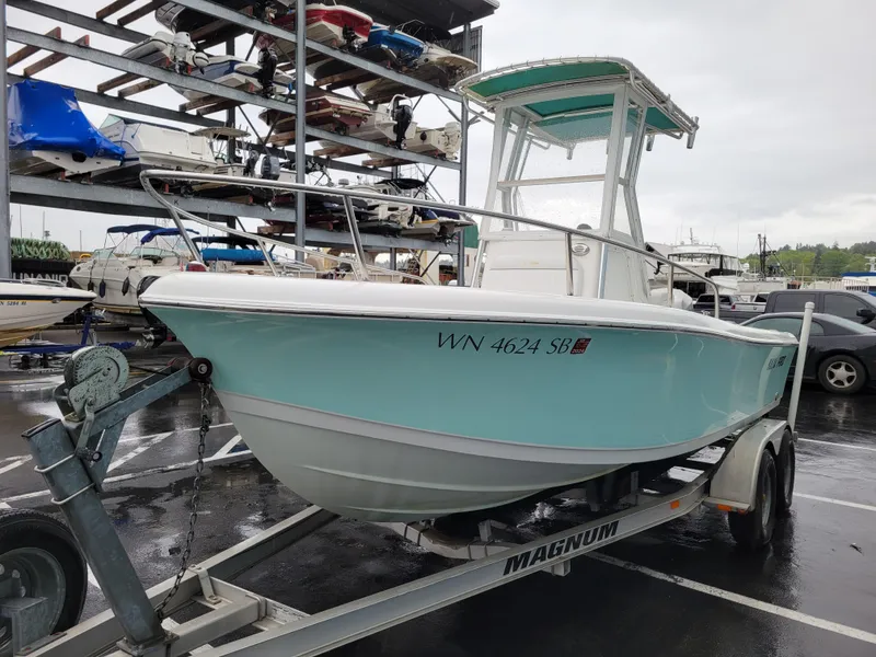 Slide: The Image of 2006 Sea Pro 196 Center Console boat on trailer in marina parking lot. - 0