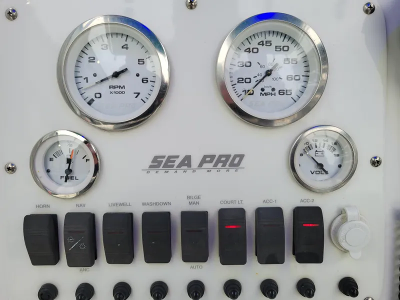 Slide: The Image of Control panel of a 2006 Sea Pro 196 Center Console boat with gauges and switches. - 11