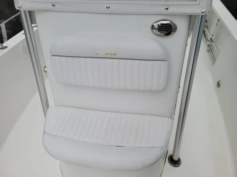 Slide: The Image of 2006 Sea Pro 196 Center Console boat seat with white upholstery and chrome accents. - 15