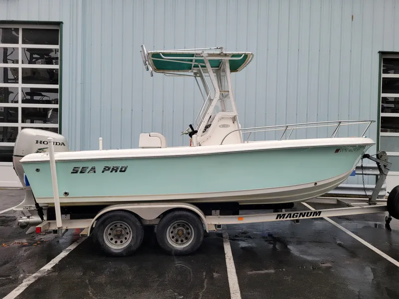 Slide: The Image of 2006 Sea Pro 196 Center Console boat on trailer, parked outdoors. - 2