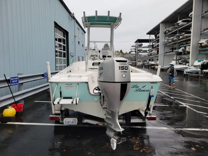 Slide: The Image of 2006 Sea Pro 196 Center Console boat with Honda 150 outboard motor, parked in marina. - 4