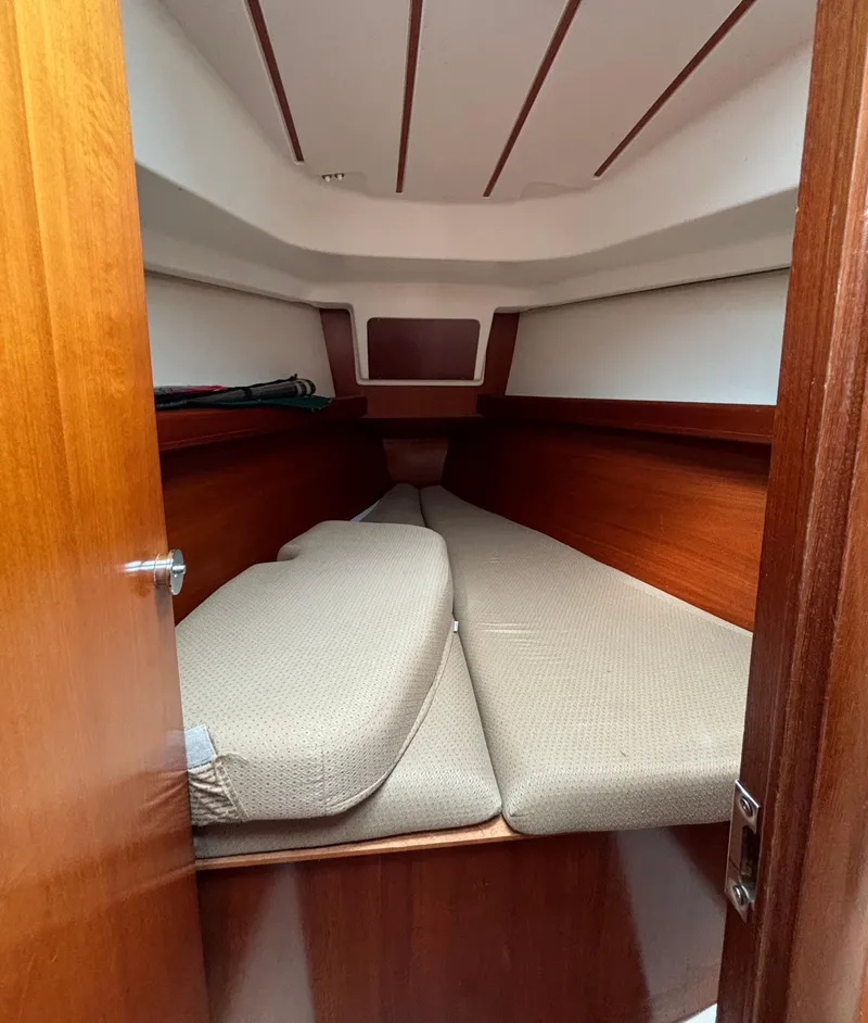Slide: The Image of 2001 Beneteau 361 cabin interior with wooden finish and cushioned seating. - 15
