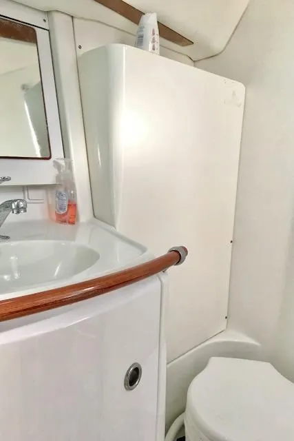 Slide: The Image of 2001 Beneteau 361 yacht bathroom with sink, mirror, and toilet. - 17