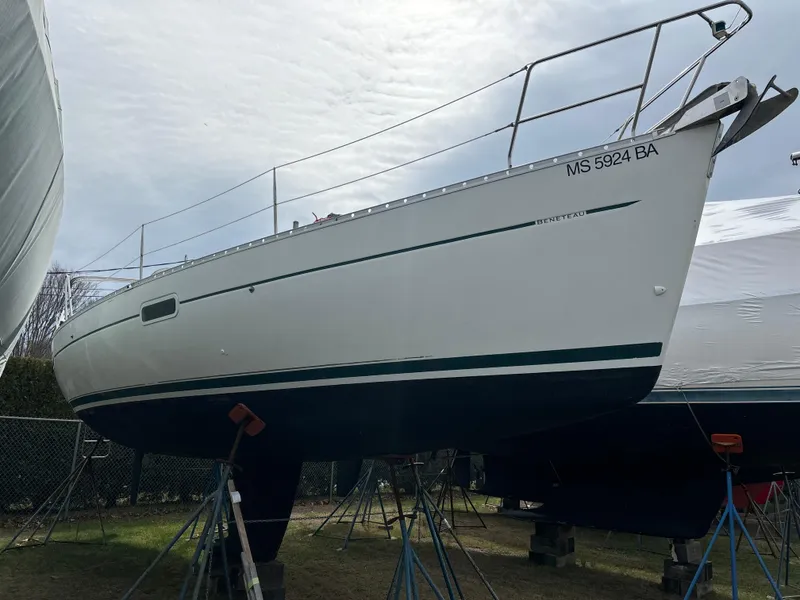 Slide: The Image of 2001 Beneteau 361 sailboat on stands, white hull, outdoor storage. - 2