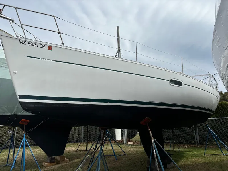 Slide: The Image of 2001 Beneteau 361 sailboat on stands, white hull, outdoor storage. - 3