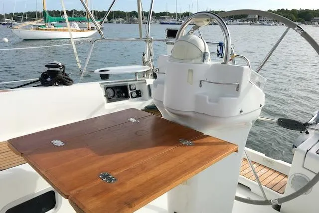 Slide: The Image of Cockpit of 2001 Beneteau 361 sailboat with wooden table and steering wheel. - 6