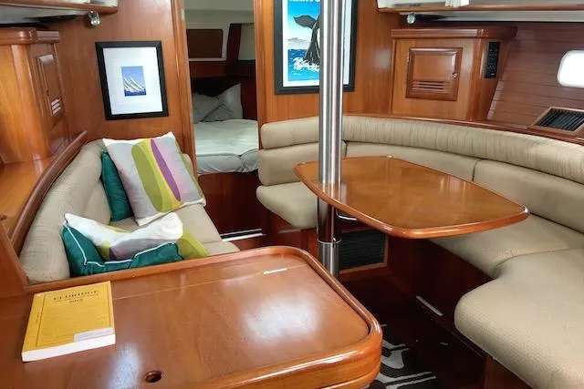 Slide: The Image of Interior of 2001 Beneteau 361 sailboat with cozy seating and wooden finishes. - 7