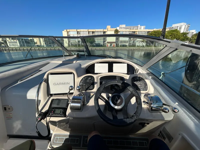 Slide: The Image of Helm of 2004 Sea Ray 340 Sundancer with Garmin navigation, docked in a marina. - 11