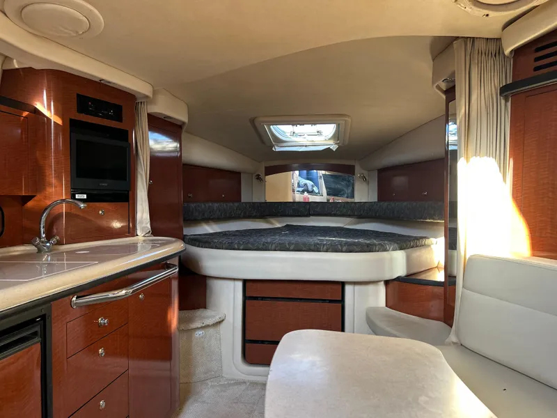 Slide: The Image of Interior of 2004 Sea Ray 340 Sundancer yacht with luxurious cabin and modern amenities. - 14