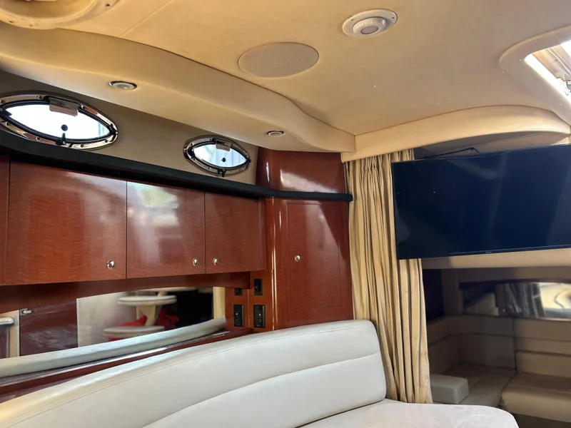 Slide: The Image of Interior of 2004 Sea Ray 340 Sundancer yacht with wood cabinets and a mounted TV. - 21