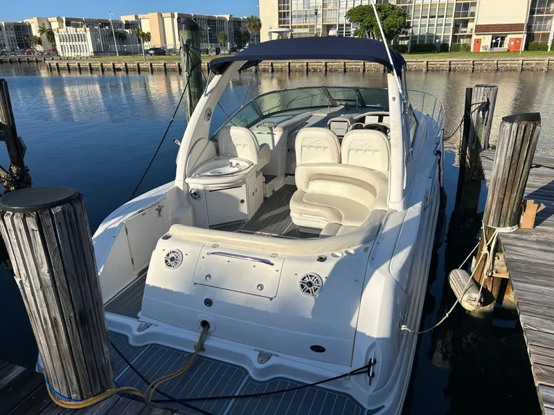 Slide: The Image of 2004 Sea Ray 340 Sundancer docked, featuring spacious seating and sleek design. - 4