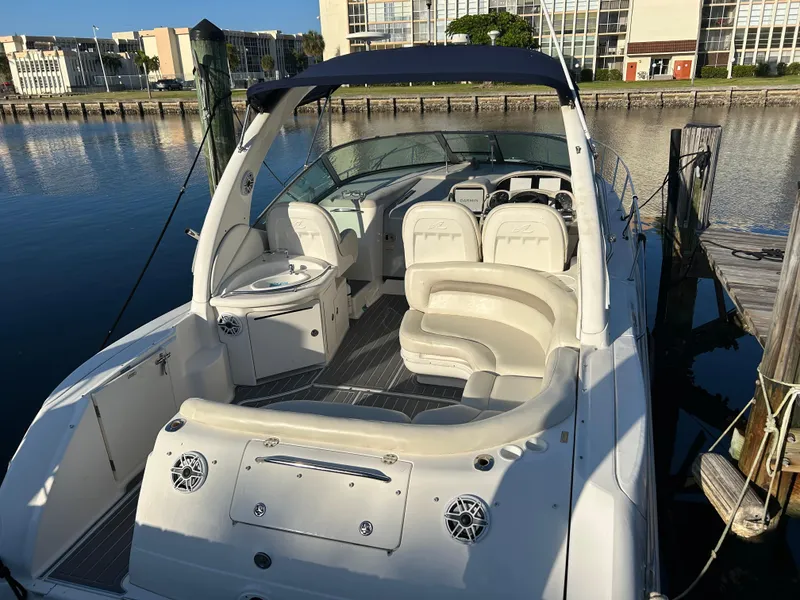 Slide: The Image of 2004 Sea Ray 340 Sundancer boat docked, featuring spacious seating and sleek design. - 5