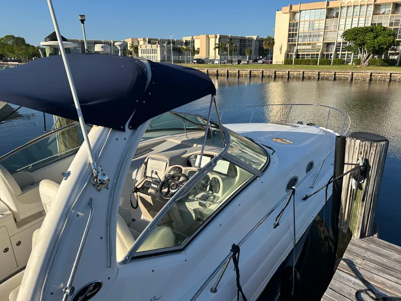 Slide: The Image of 2004 Sea Ray 340 Sundancer docked at marina, sunny day, waterfront view. - 6
