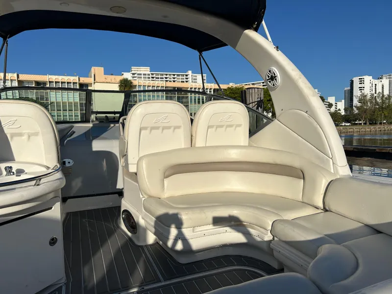 Slide: The Image of 2004 Sea Ray 340 Sundancer boat interior with white seating and modern design. - 7