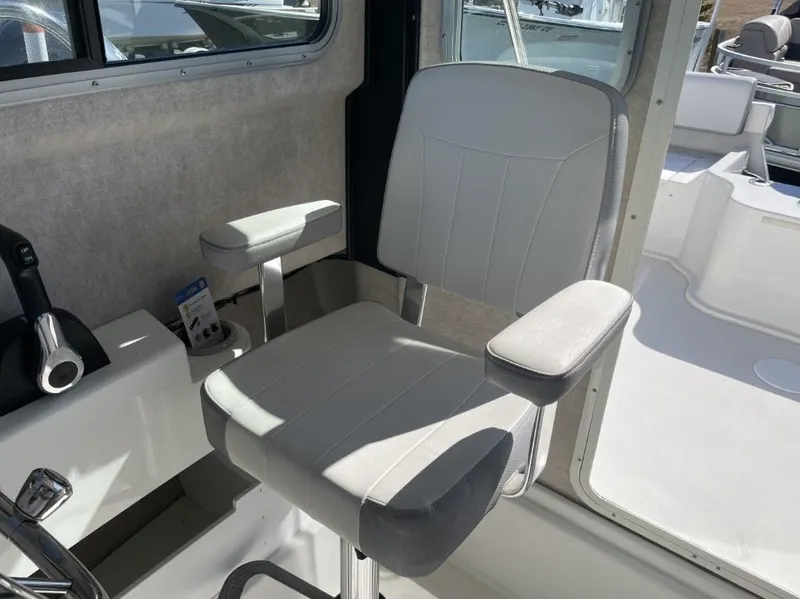 Slide: The Image of Captain's chair inside a 2022 Parker 2120 boat, featuring a sleek, modern design. - 12
