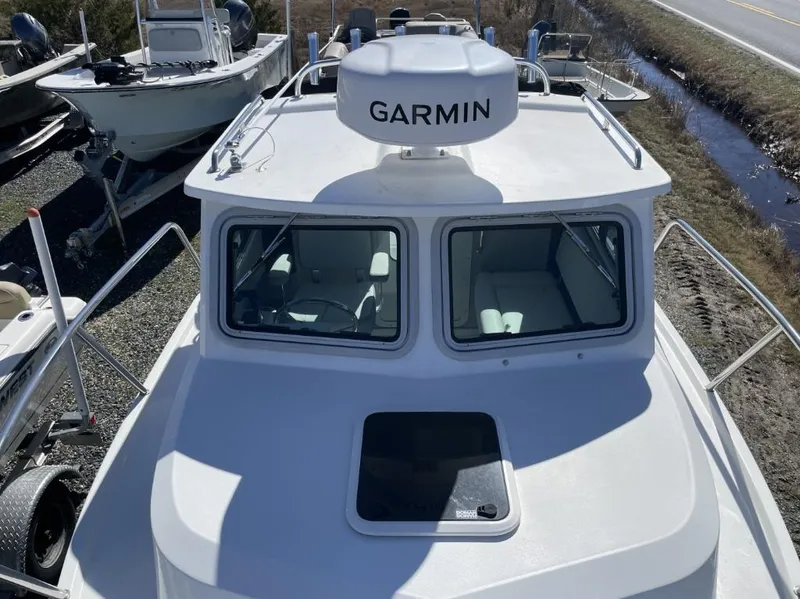 Slide: The Image of 2022 Parker 2120 boat with Garmin radar, docked near a road. - 15