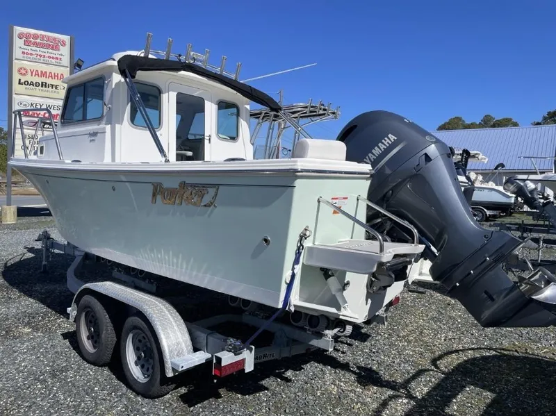 Slide: The Image of 2022 Parker 2120 boat with Yamaha engine on trailer at dealership. - 2