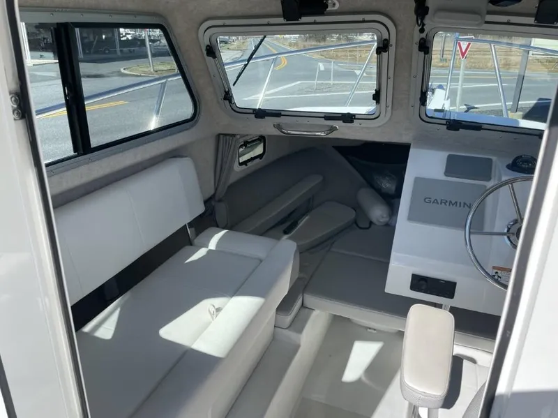 Slide: The Image of Interior of a 2022 Parker 2120 boat with seating and Garmin navigation system. - 7
