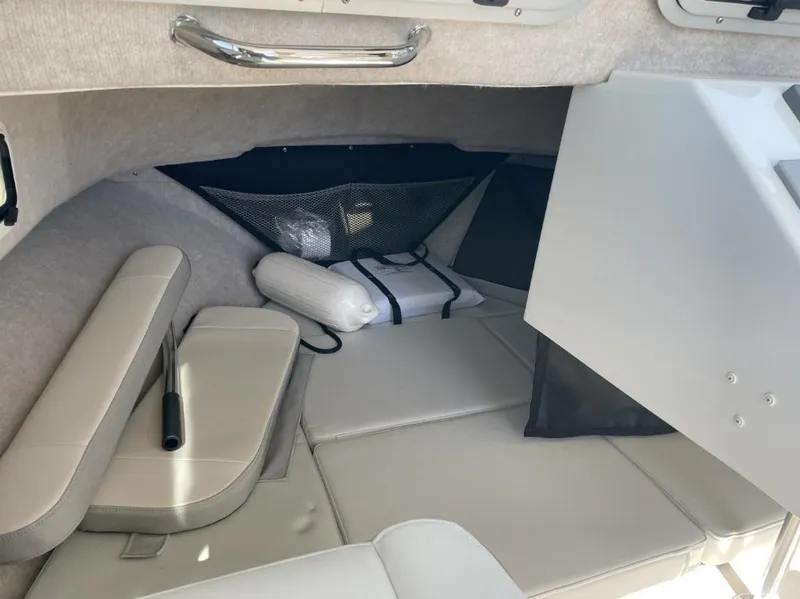 Slide: The Image of Interior cabin of 2022 Parker 2120 boat with cushioned seating and storage. - 9