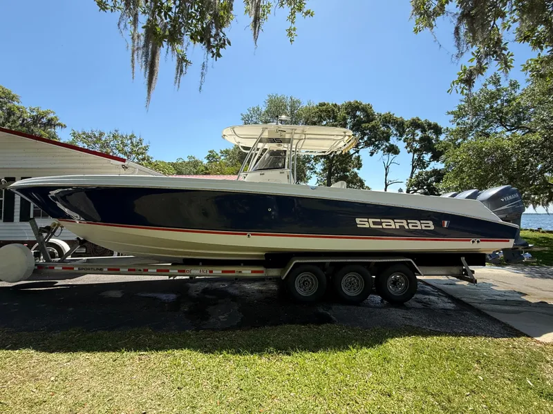 Slide: The Image of 2007 Wellcraft 352 Tournament boat on trailer, parked outdoors, under clear blue sky. - 10