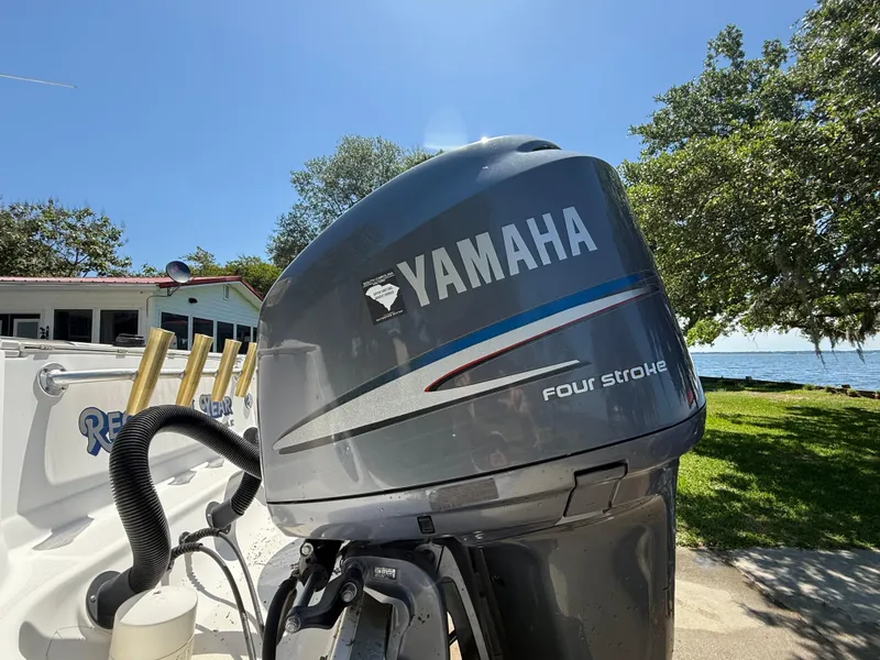 Slide: The Image of Yamaha four-stroke engine on 2007 Wellcraft 352 Tournament boat, sunny outdoor setting. - 12