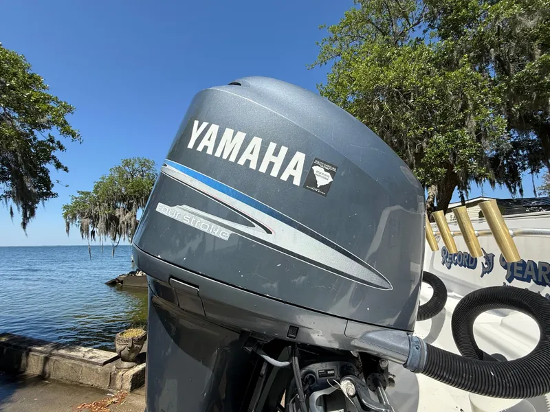 Slide: The Image of Yamaha outboard motor on 2007 Wellcraft 352 Tournament boat by a scenic lake. - 13