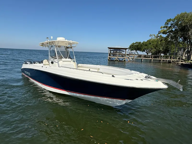 Slide: The Image of 2007 Wellcraft 352 Tournament boat on calm water near a dock. - 2