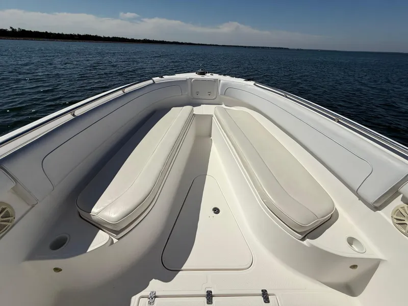 Slide: The Image of Bow view of 2007 Wellcraft 352 Tournament boat with white seating and open water backdrop. - 25