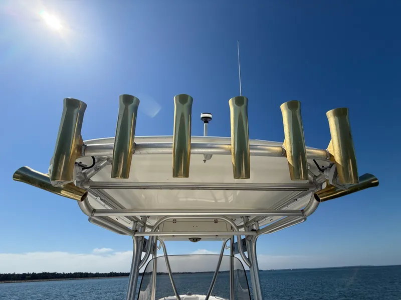 Slide: The Image of T-top of 2007 Wellcraft 352 Tournament boat with rod holders against clear blue sky. - 33