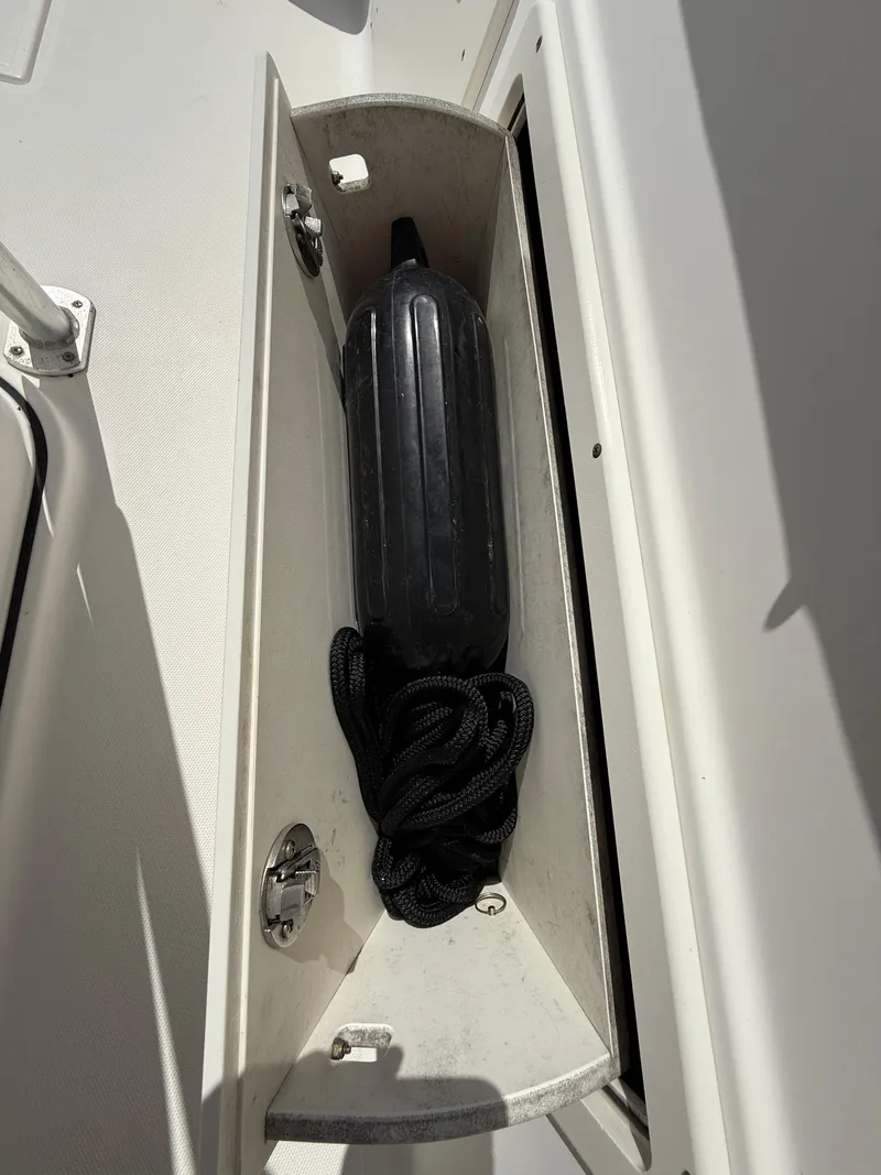 Slide: The Image of Storage compartment on a 2007 Wellcraft 352 Tournament boat with a black fender. - 46