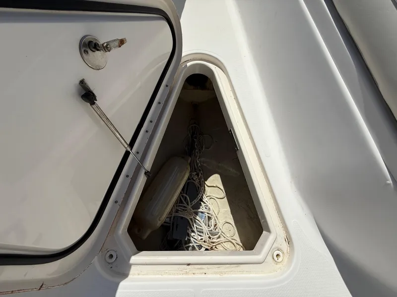 Slide: The Image of Open storage compartment on 2007 Wellcraft 352 Tournament boat, showing ropes and equipment. - 47
