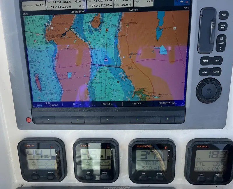Slide: The Image of Navigation system and gauges on a 2008 Pursuit C 250 Center Console boat. - 10