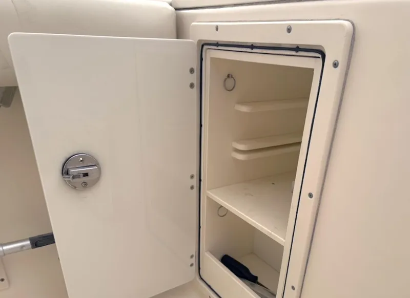 Slide: The Image of Open storage compartment on a 2008 Pursuit C 250 Center Console boat. - 12
