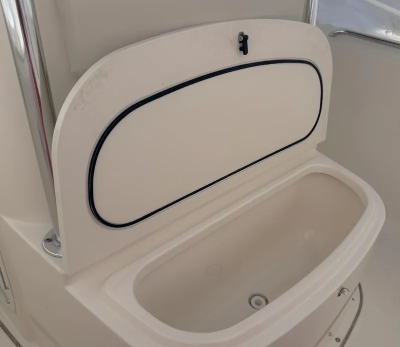 Slide: The Image of 2008 Pursuit C 250 Center Console storage compartment with open lid. - 18