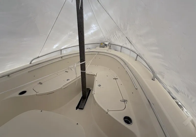 Slide: The Image of 2008 Pursuit C 250 Center Console boat under protective cover, showcasing spacious deck layout. - 19