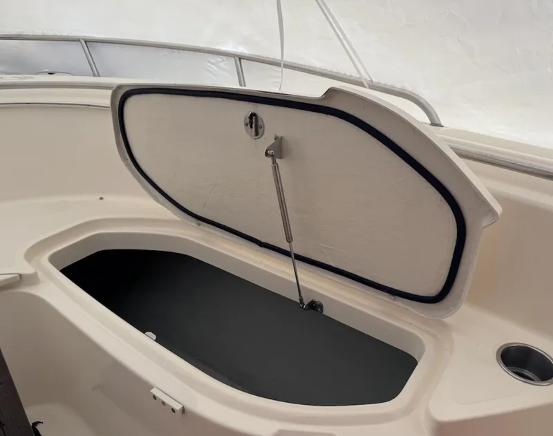 Slide: The Image of Open storage compartment on 2008 Pursuit C 250 Center Console boat. - 20