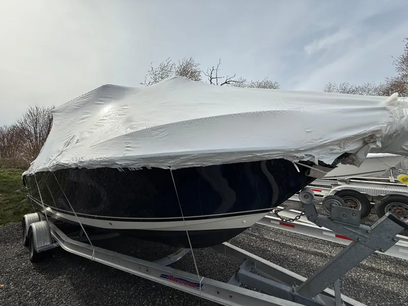 Slide: The Image of 2008 Pursuit C 250 Center Console boat covered on trailer, outdoor storage. - 25