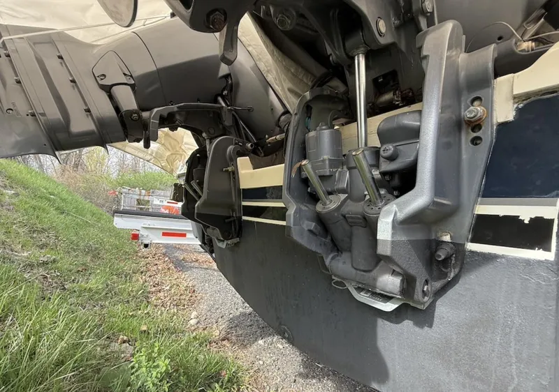 Slide: The Image of 2008 Pursuit C 250 Center Console boat engine detail, showing mechanical components and trailer. - 26