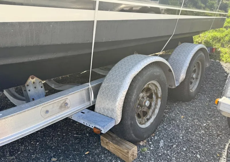 Slide: The Image of Trailer for 2008 Pursuit C 250 Center Console boat on gravel. - 28