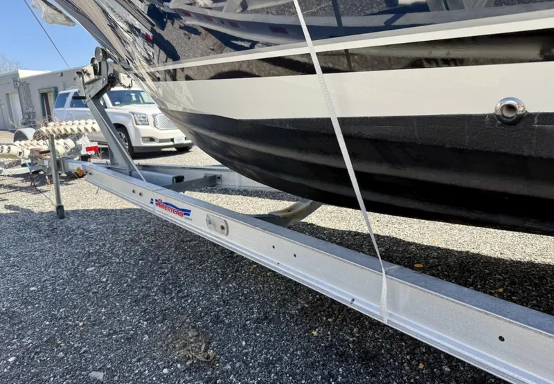 Slide: The Image of 2008 Pursuit C 250 Center Console boat on trailer, parked on gravel. - 29