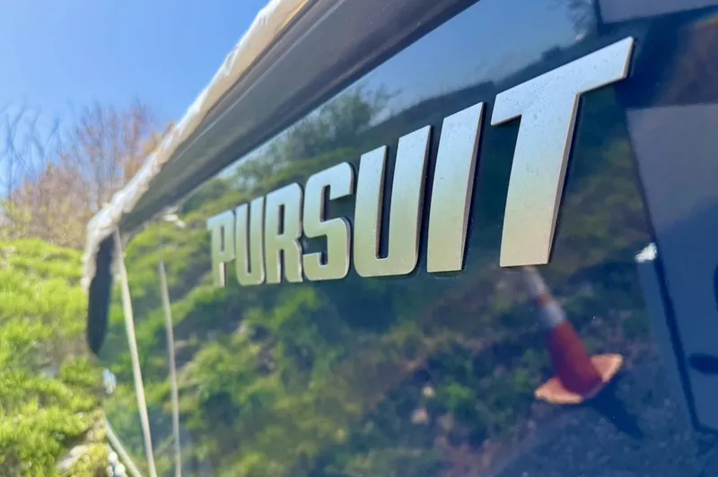 Slide: The Image of 2008 Pursuit C 250 Center Console boat with logo, outdoors in sunlight. - 3