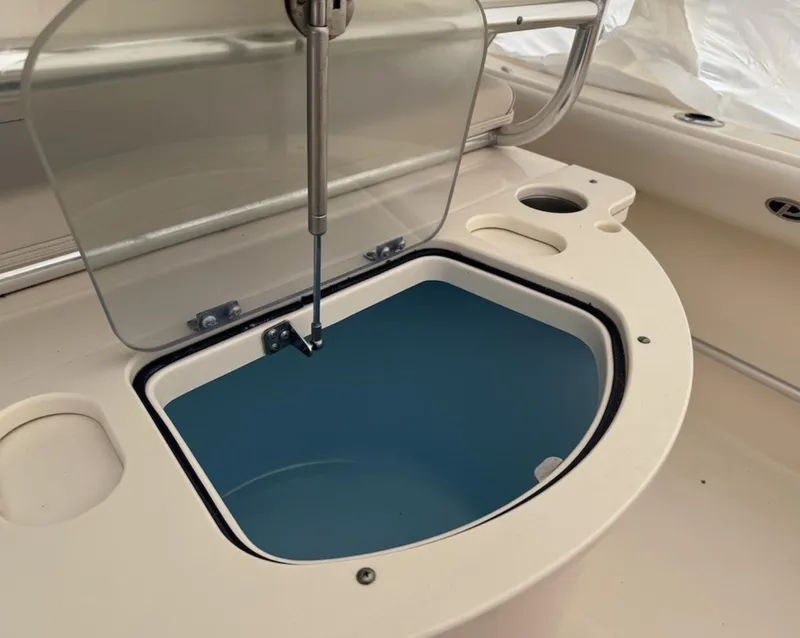 Slide: The Image of 2008 Pursuit C 250 Center Console boat with open storage compartment. - 6