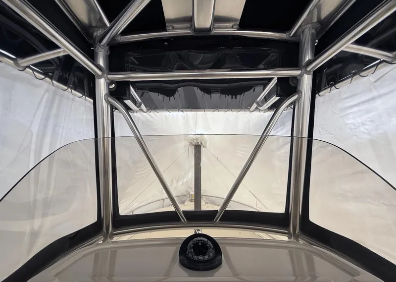 Slide: The Image of 2008 Pursuit C 250 Center Console interior with compass and protective canopy. - 8