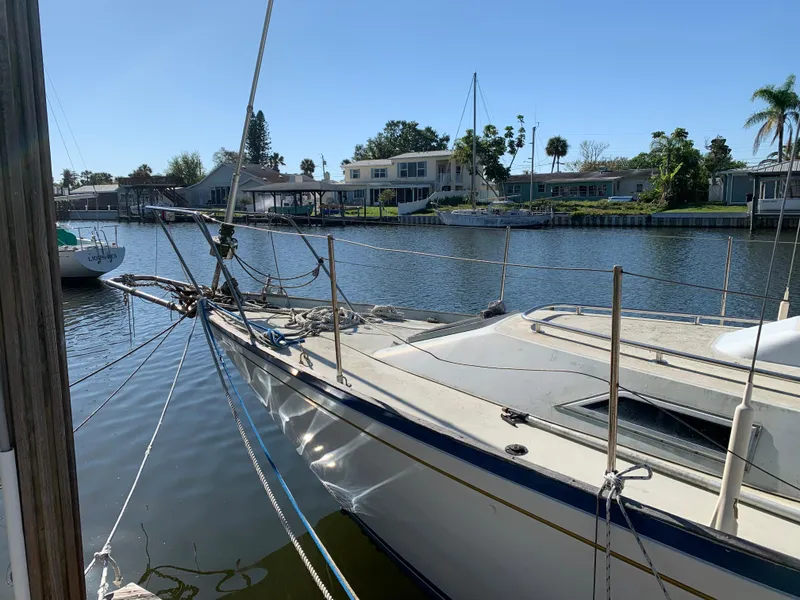 Slide: The Image of 1978 Camper & Nicholsons Sloop docked in a serene marina setting. - 1
