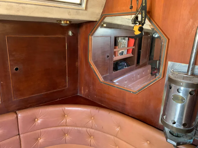 Slide: The Image of Interior of a 1978 Camper & Nicholsons Sloop with wood paneling and leather seating. - 14